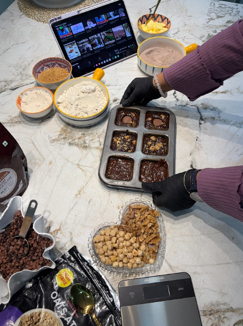 Ankita preparing a fresh batch of brownies in the Grain Crumbs kitchen